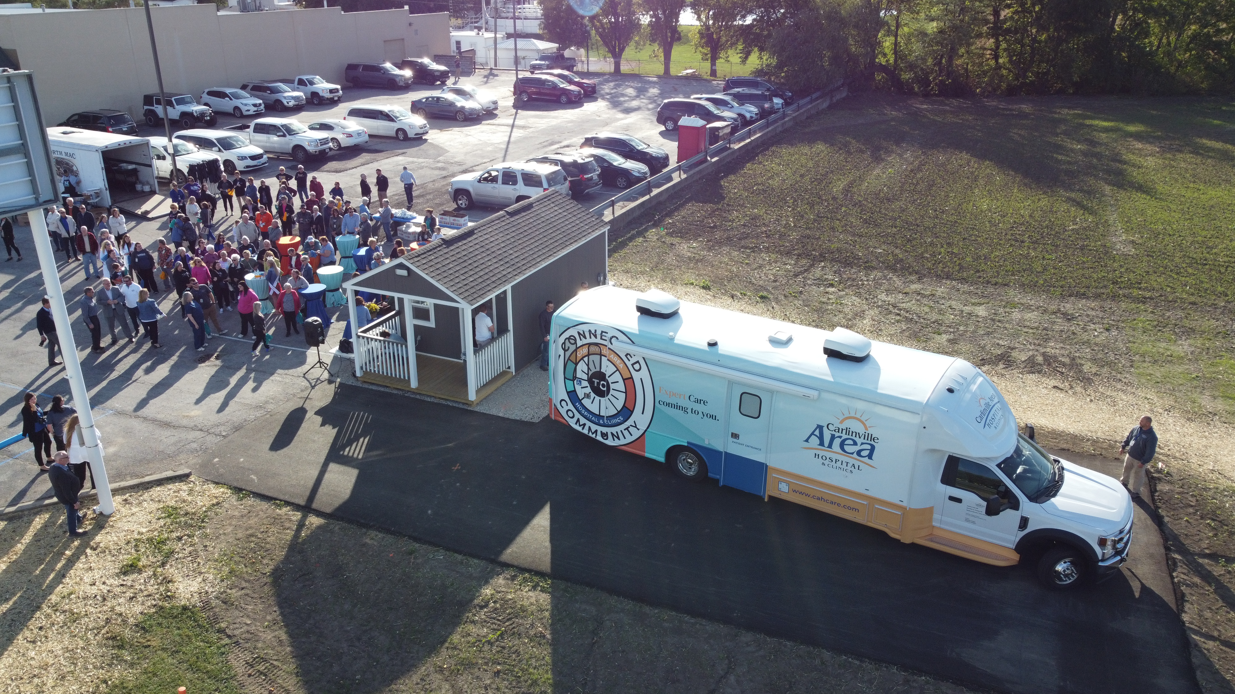 Mobile Medical Clinic parked in Virden, IL with large crowd gethered